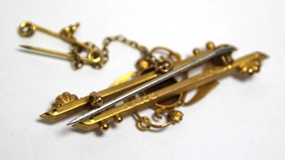 Lot 695 - An Edwardian 9ct yellow gold bar brooch set...