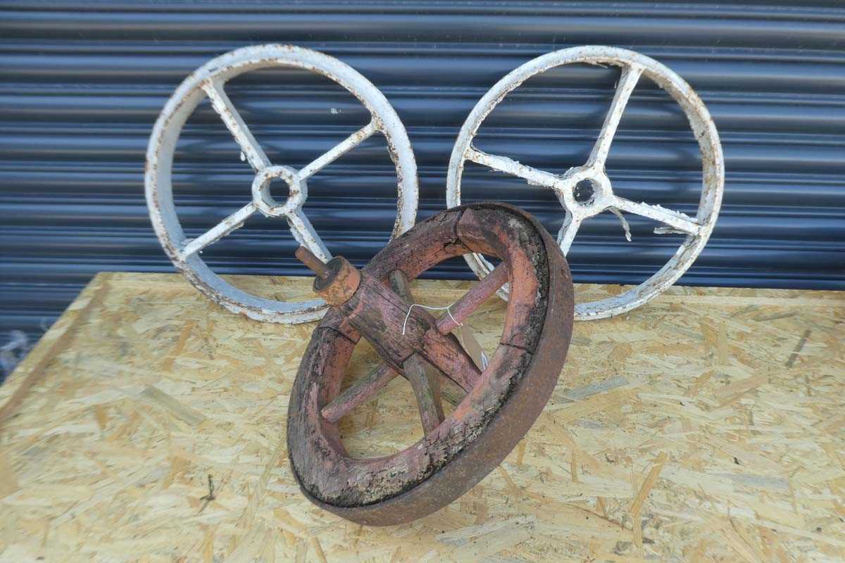 Lot 2 Cast iron wheels together with 1 woodenmetal...