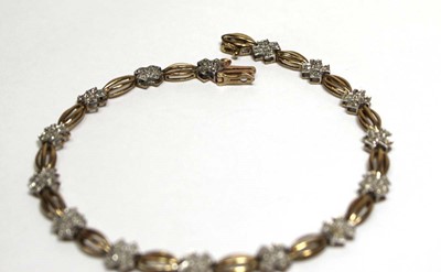 Lot 696 - A 9ct yellow gold tennis-type bracelet set...