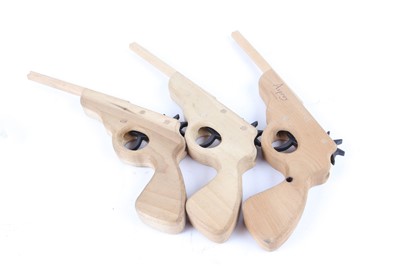 Lot 1149 - Three Asprey 'repeating' elastic band guns