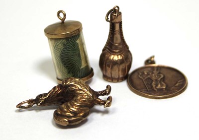 Lot 700 - Four 9ct yellow gold charms including a...