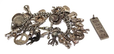 Lot 701 - A silver curblink bracelet suspending a...