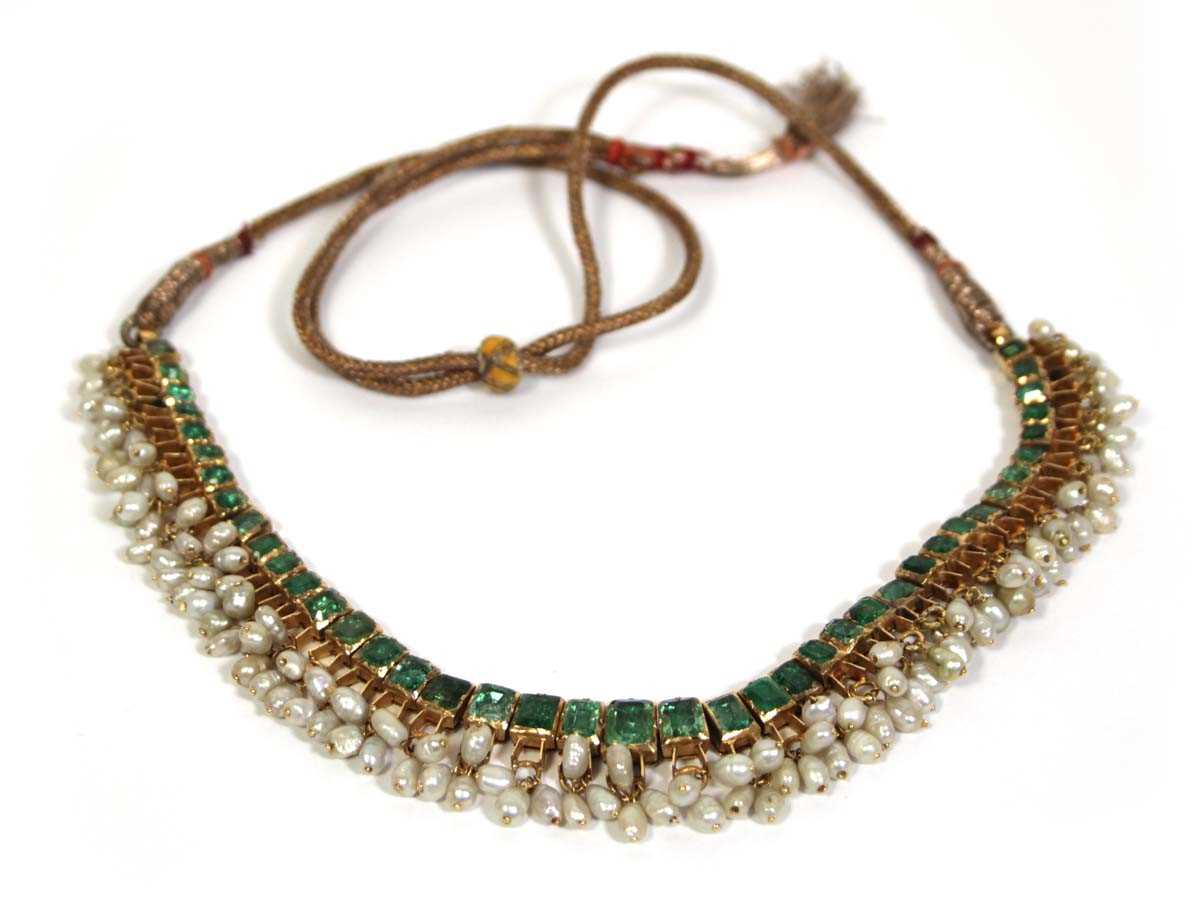 Lot 710 - An Indian cord and yellow gold necklace...