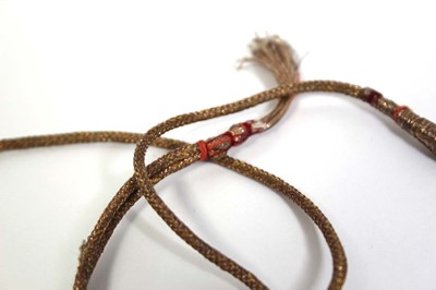 Lot 710 - An Indian cord and yellow gold necklace...