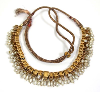 Lot 710 - An Indian cord and yellow gold necklace...