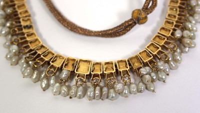 Lot 710 - An Indian cord and yellow gold necklace...