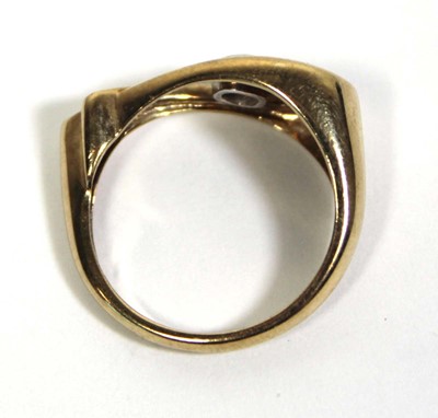 Lot 714 - A 9ct yellow gold ring set diamond in an...