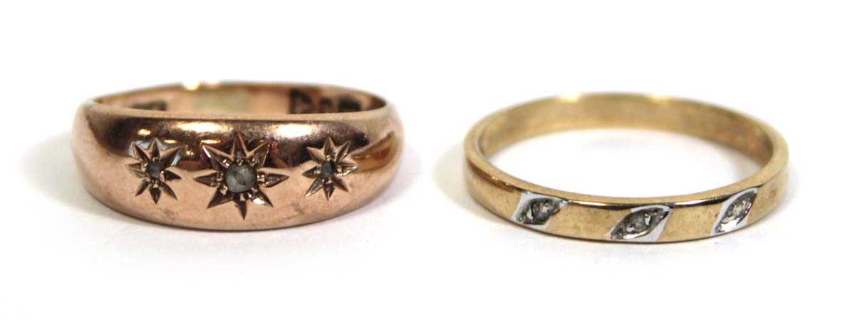 Lot 715 - A 9ct yellow gold ring set three small...