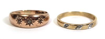 Lot 715 - A 9ct yellow gold ring set three small...