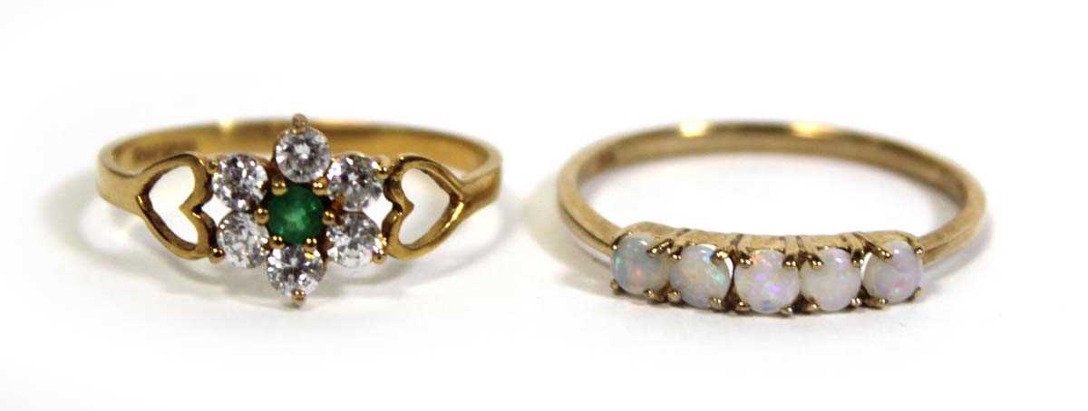 Lot 717 - A 9ct yellow gold ring set five small opals in...