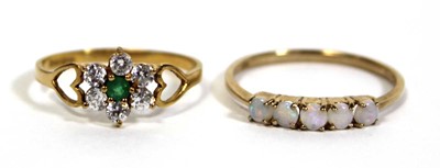Lot 717 - A 9ct yellow gold ring set five small opals in...