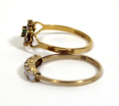 Lot 717 - A 9ct yellow gold ring set five small opals in...