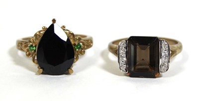 Lot 733 - Two 9ct yellow gold dress rings set green and...