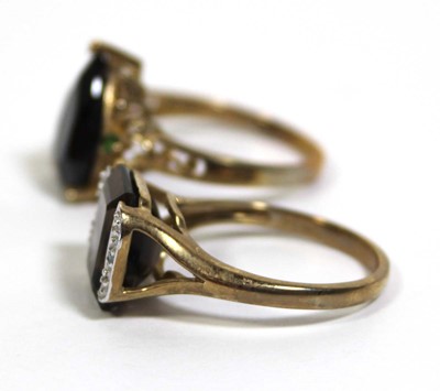 Lot 733 - Two 9ct yellow gold dress rings set green and...