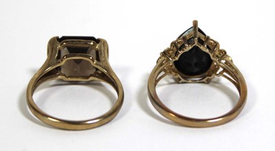Lot 733 - Two 9ct yellow gold dress rings set green and...