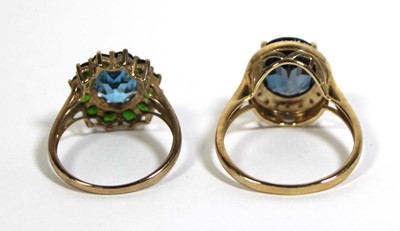 Lot 734 - Two 9ct yellow gold dress rings set green and...