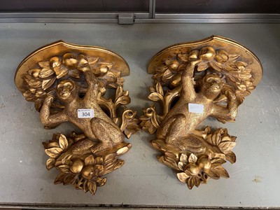 Lot 304 - Two gilt painted wooden wall shelves in the...