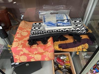 Lot 353 - An assortment of textiles to include mats,...