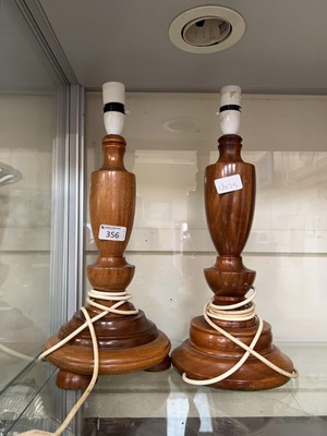 Lot 356 - Two mahogany candlesticks converted to table...