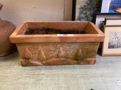 Lot 24 - A terracotta trough planter with embossed...