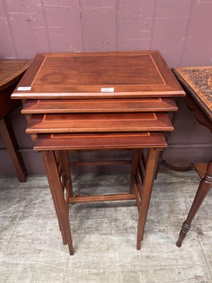 Lot 60 - A nest of four mahogany and strung occasional...