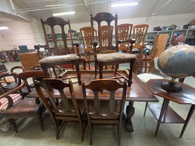 Lot 83 - A reproduction oak refectory style dining...