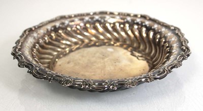 Lot 327 - A circular stamped silver dish of scrolled...