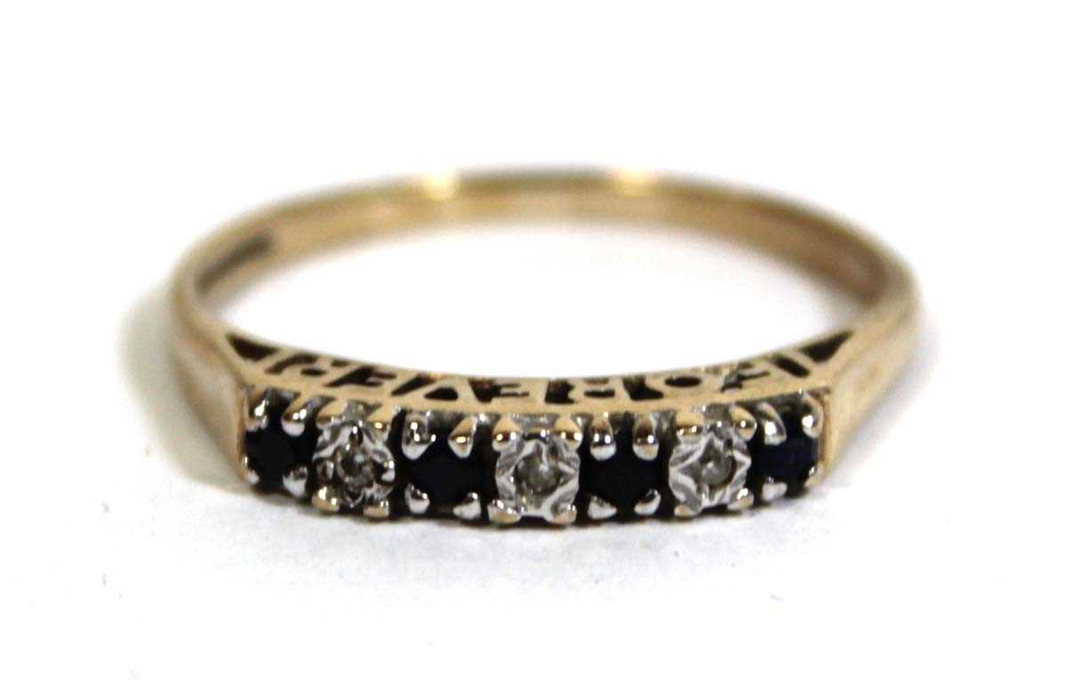 Lot 746 - A 9ct yellow gold 'Forever' ring set four...