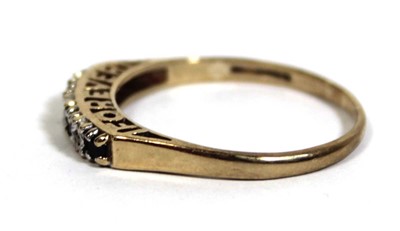 Lot 746 - A 9ct yellow gold 'Forever' ring set four...