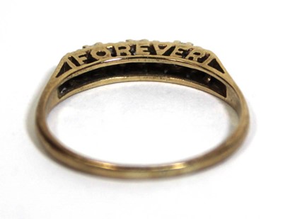Lot 746 - A 9ct yellow gold 'Forever' ring set four...