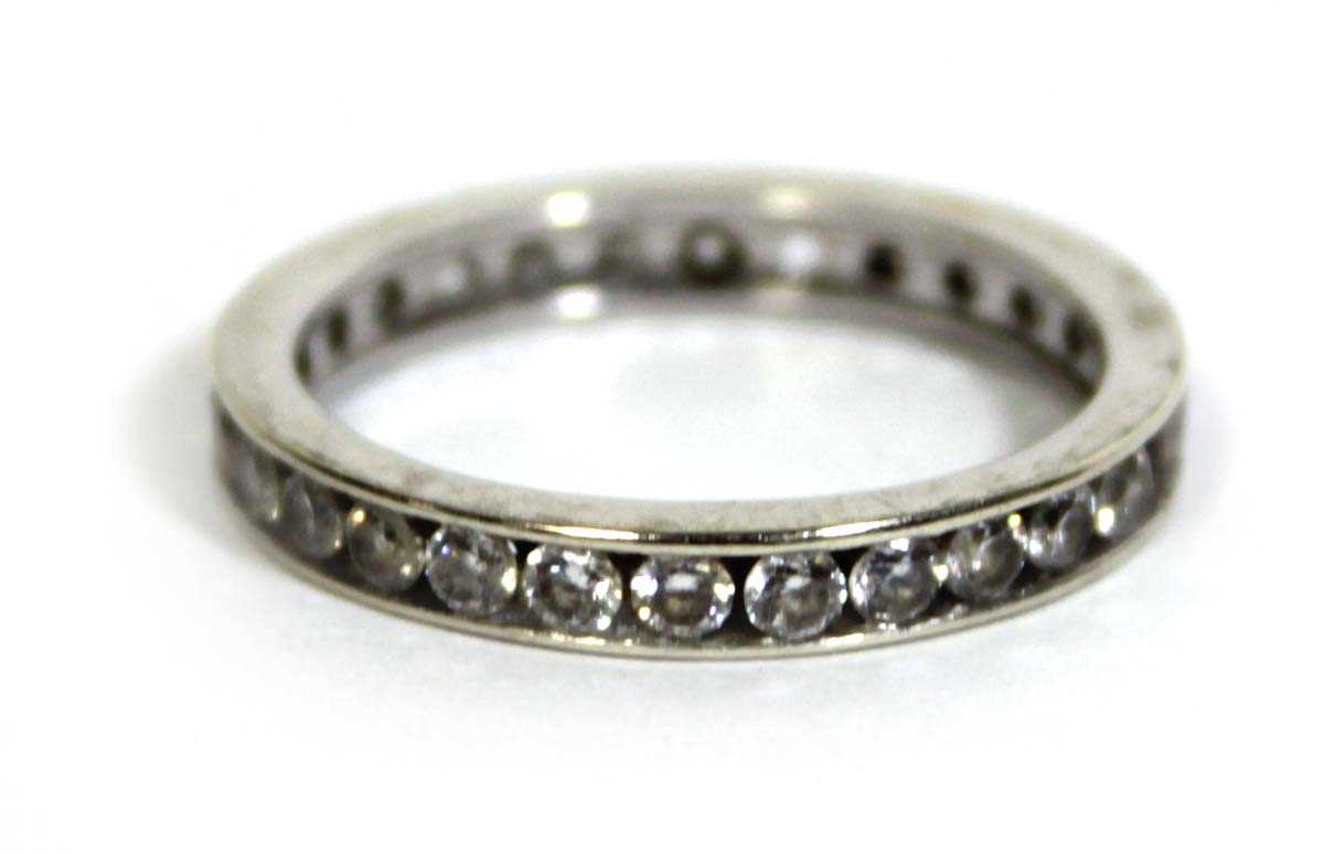 Lot 748 - A 9ct white gold eternity ring set cubic...