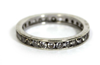Lot 748 - A 9ct white gold eternity ring set cubic...