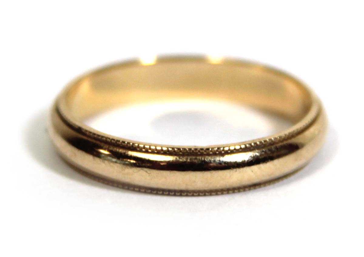 Lot 749 - A 14ct yellow gold wedding band with beaded...