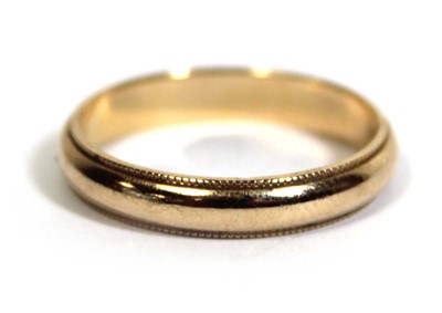 Lot 749 - A 14ct yellow gold wedding band with beaded...