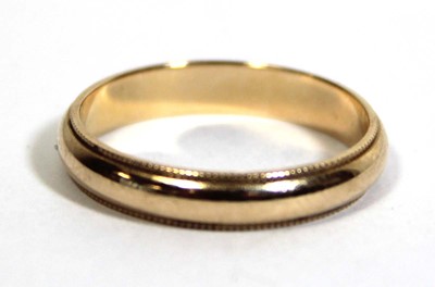 Lot 749 - A 14ct yellow gold wedding band with beaded...