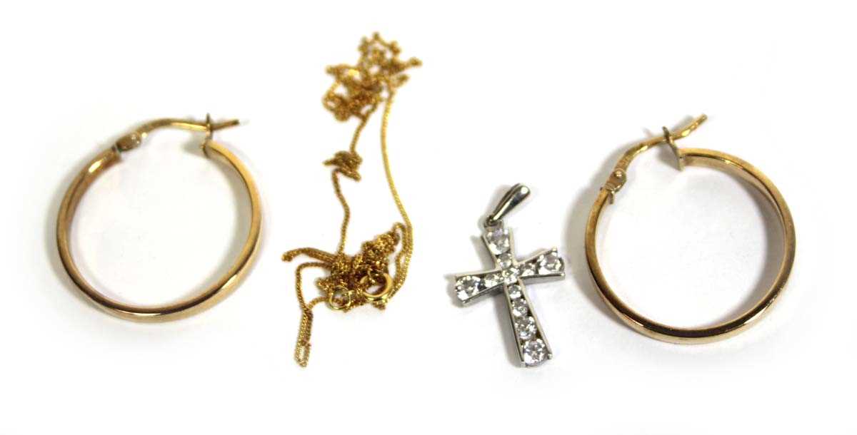 Lot 750 - A 9ct white gold cross pendant set cubic...