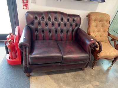 Lot 1011 - Burgundy leather upholstered 2 seater button...