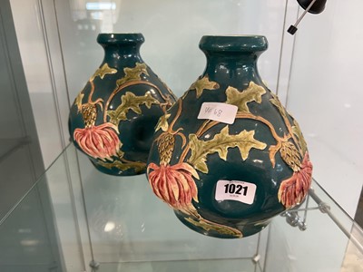 Lot 1021 - Pair of green vases with thistle motif