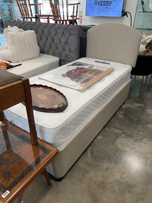 Lot 1036 - Beige upholstered single divan bed base with...