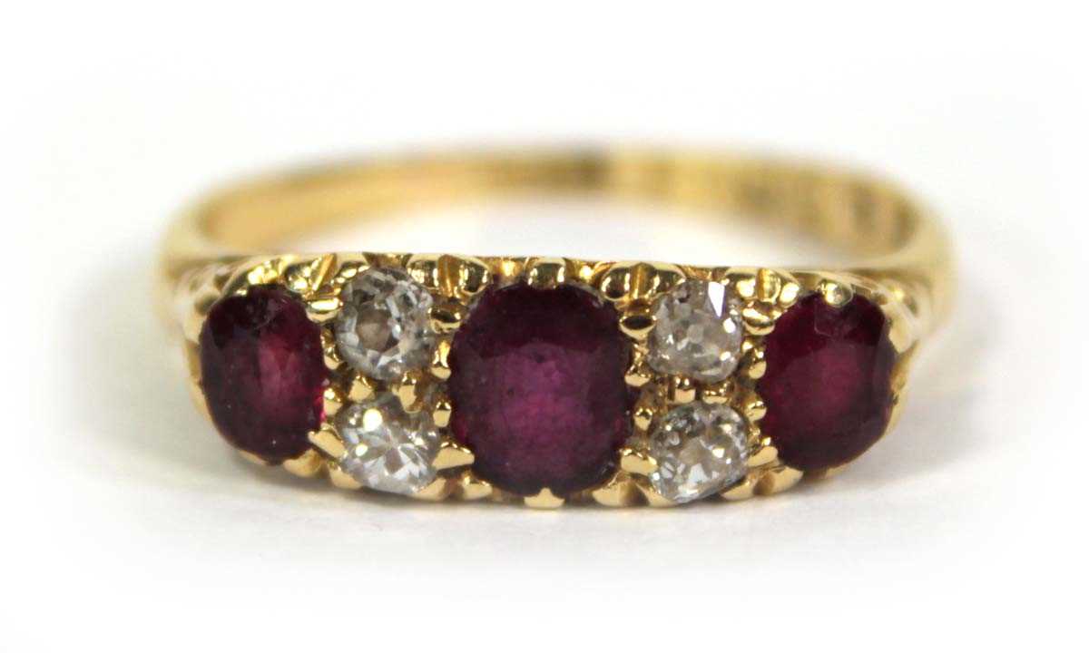 Lot 754 - An 18ct yellow gold ring set three graduated...