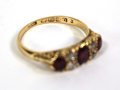 Lot 754 - An 18ct yellow gold ring set three graduated...