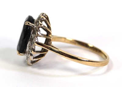Lot 755 - A 9ct yellow gold cluster ring set oval...