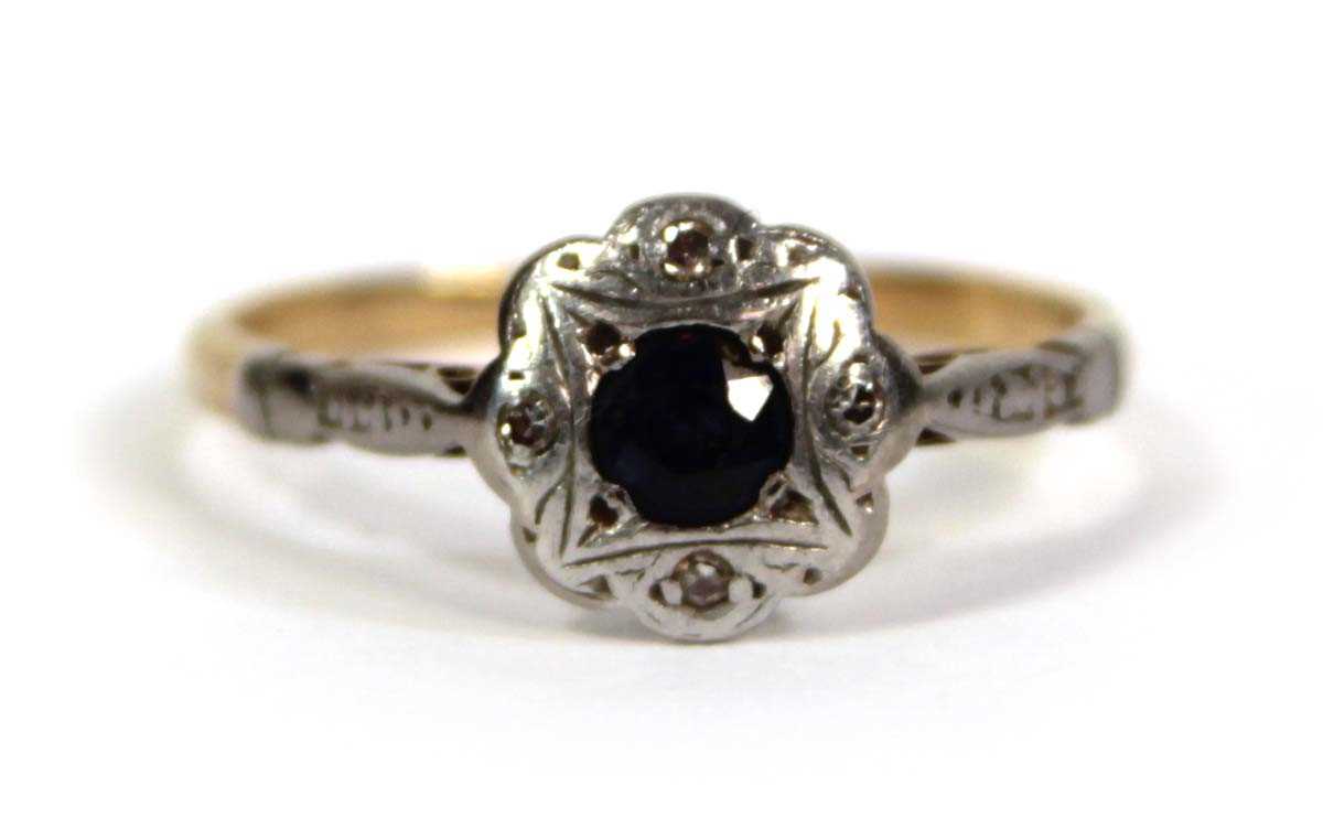 Lot 756 - An 18ct yellow gold ring set small sapphire...