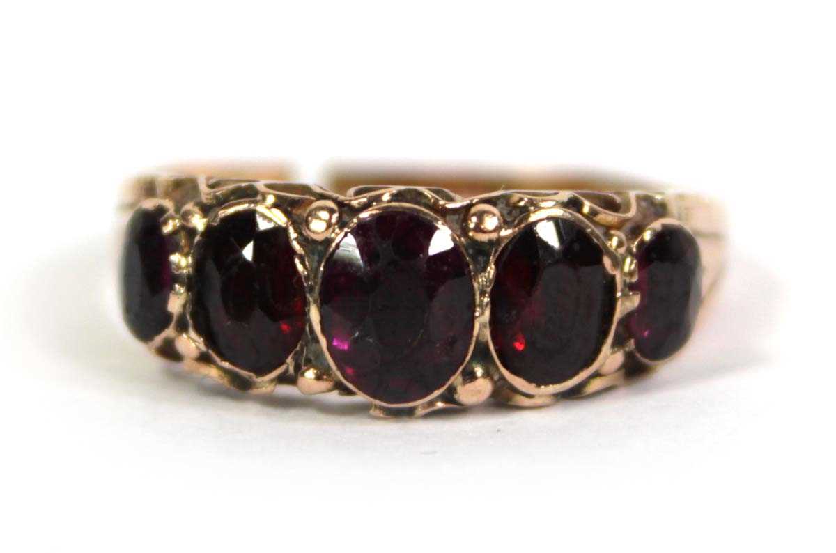Lot 757 - A 9ct yellow gold ring set five graduated...