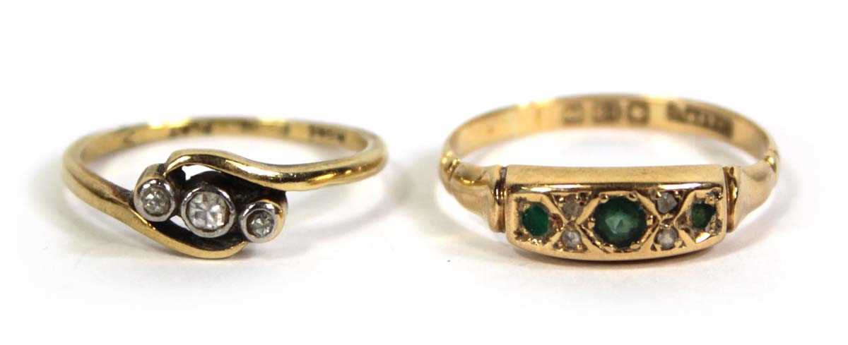 Lot 774 - An 18ct yellow gold crossover ring set three...