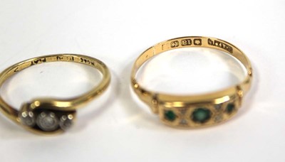 Lot 774 - An 18ct yellow gold crossover ring set three...