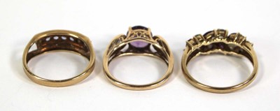 Lot 775 - Three 9ct yellow gold rings set small diamonds,...