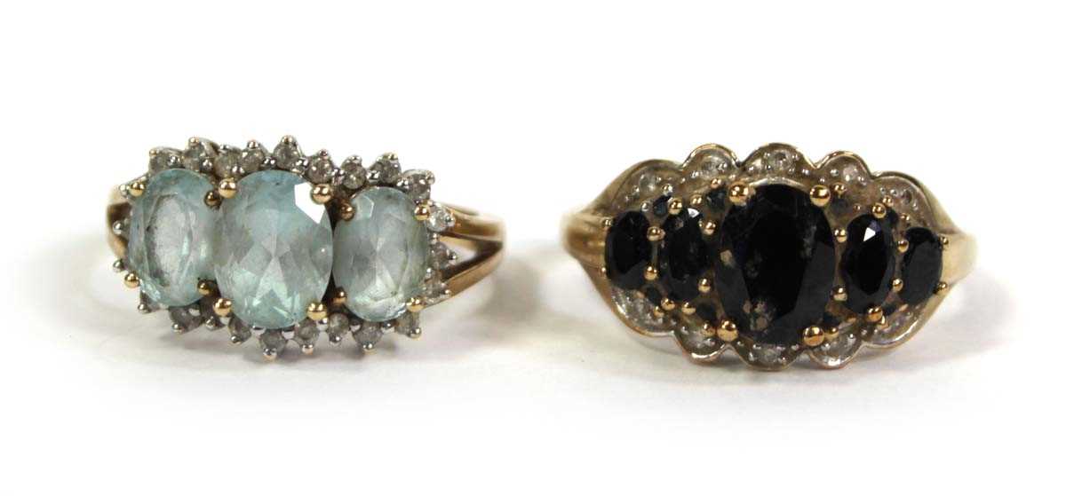 Lot 776 - Two 9ct yellow gold rings, each set blue...