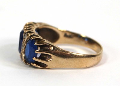 Lot 777 - A 9ct yellow gold dress ring set three oval...