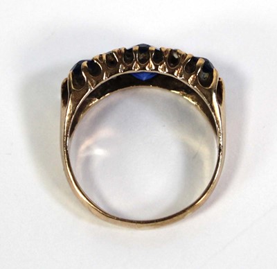 Lot 777 - A 9ct yellow gold dress ring set three oval...